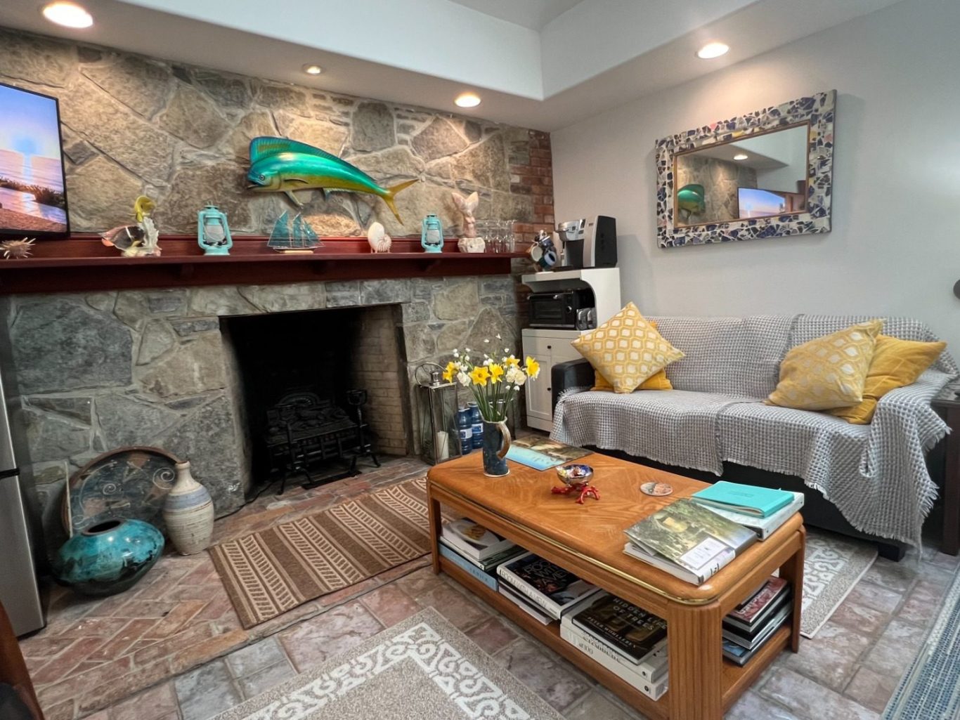 Historic Rumford stone fireplace and cozy living room sitting area inside the luxury guest suite at Wind in the Willows Oasis.